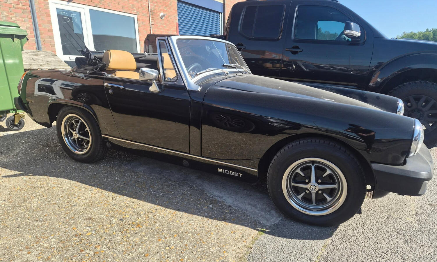Fully Restored Black convertible MG Midget with Cream Interior